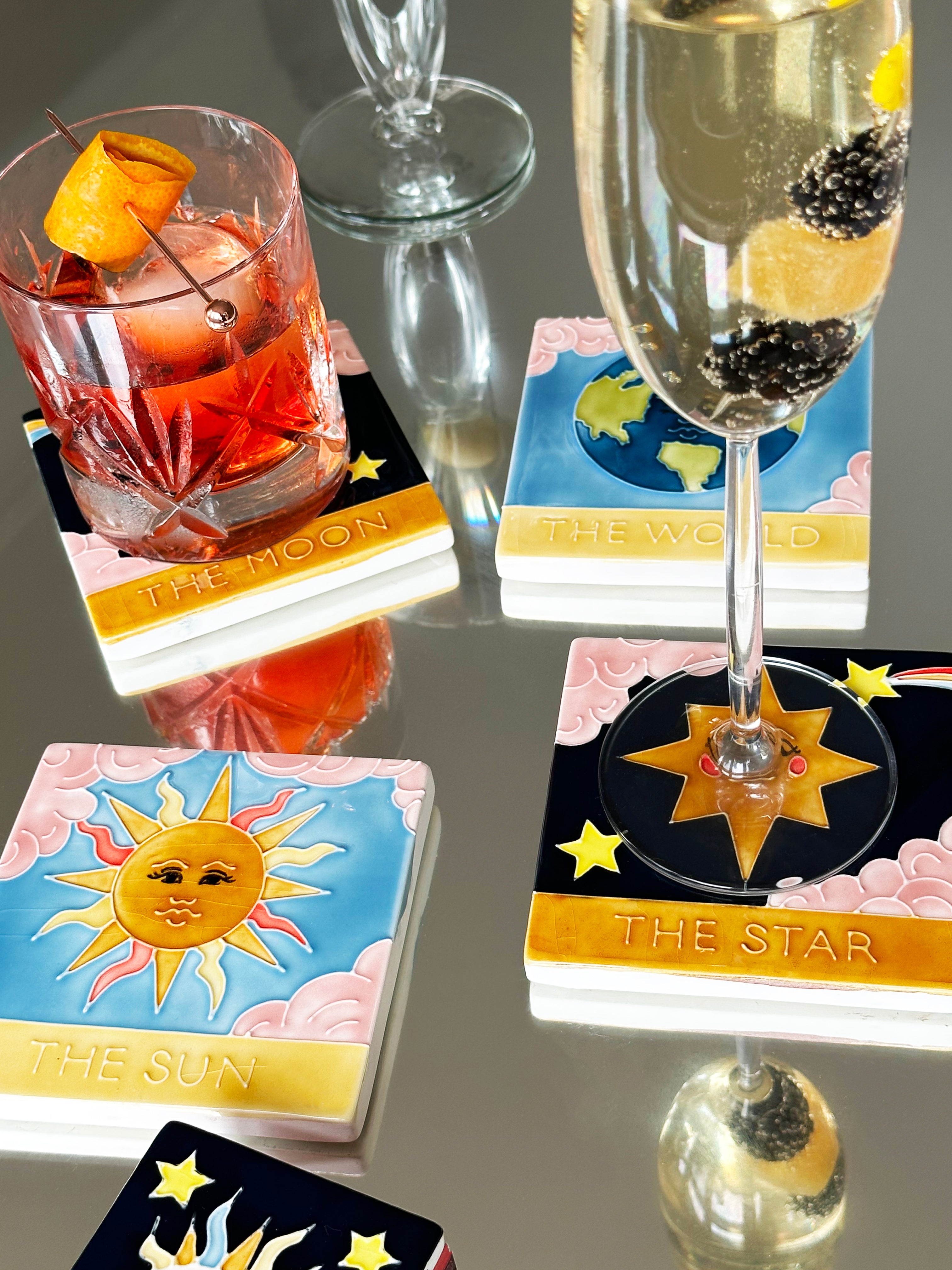 Beautiful hand painted ceramic tarot coaster set. Featuring tarot cards The Moon, The Sun, The Star, The World. Made by hand in Staffordshire, England. CC Jo Laing.