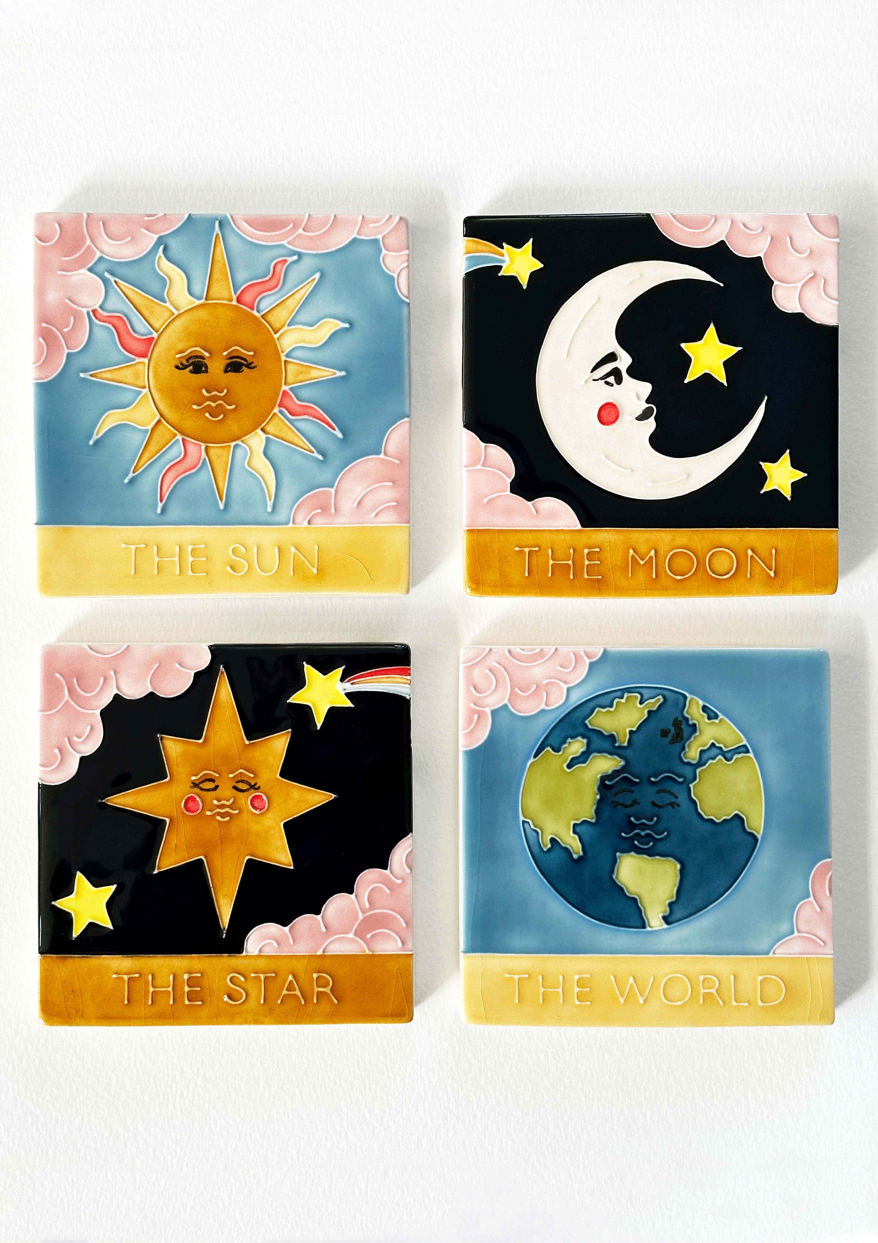 Beautiful hand painted ceramic tarot coaster set. Featuring tarot cards The Moon, The Sun, The Star, The World. Made by hand in Staffordshire, England. CC Jo Laing.