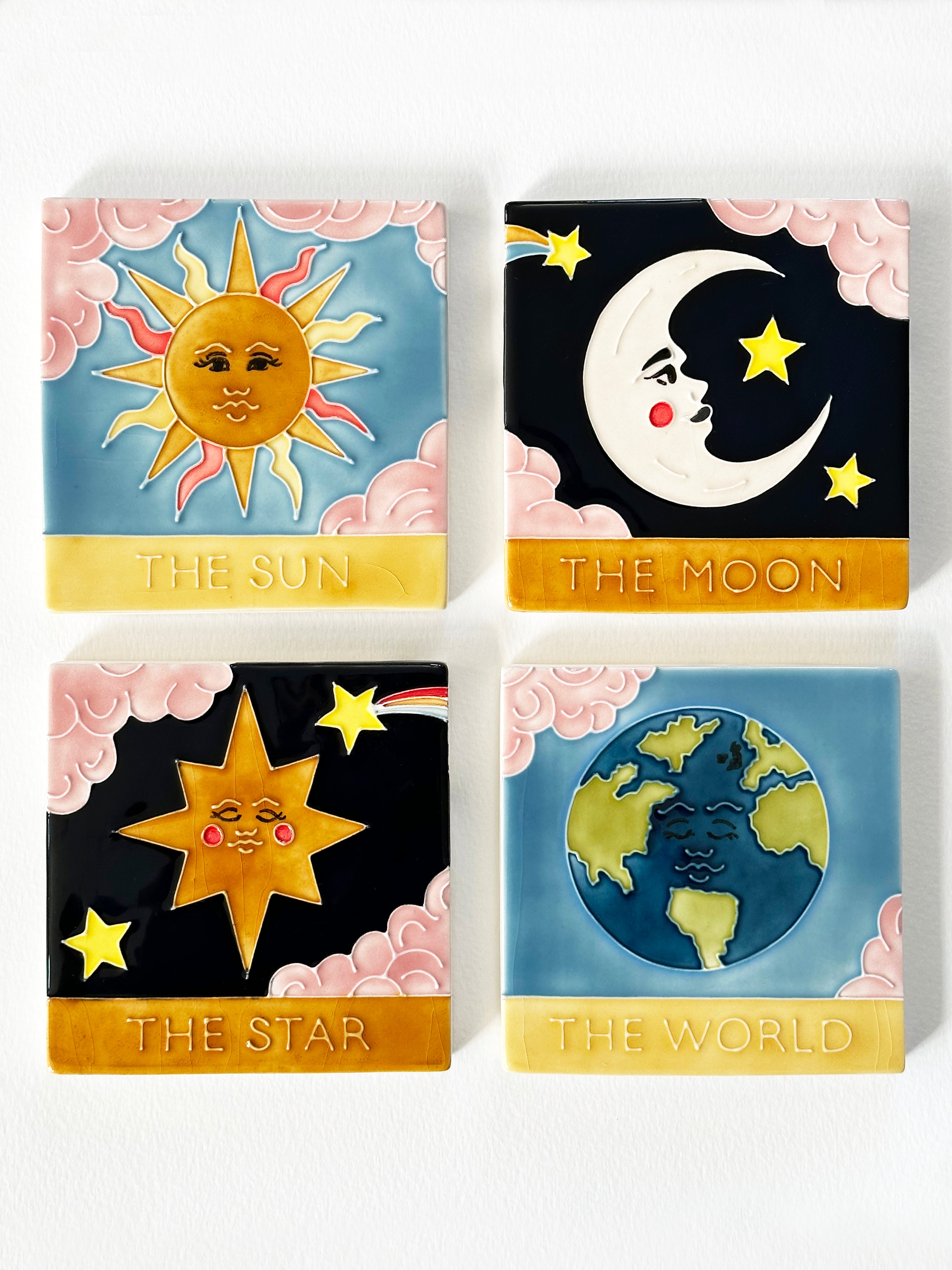 Beautiful hand painted ceramic tarot coaster set. Featuring tarot cards The Moon, The Sun, The Star, The World. Made by hand in Staffordshire, England. CC Jo Laing.